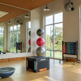 workout studio with equipment and large windows