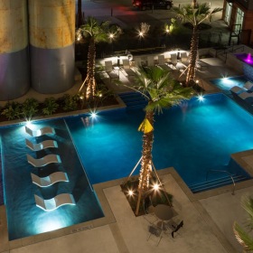 a pool with trees and lights