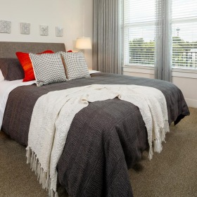 a bedroom with a bed and a window